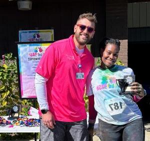 Runner and cancer survivor, Delisal Cole, is pictured with Nathan Gautier, Development Office – Special Events at Saint Francis Foundation
