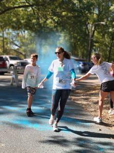 A runner crosses the finish line at Color Dash 2022