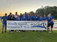 Members of the Friends of Saint Francis pose with a banner at the 2023 Friends of Saint Francis Golf Tournament